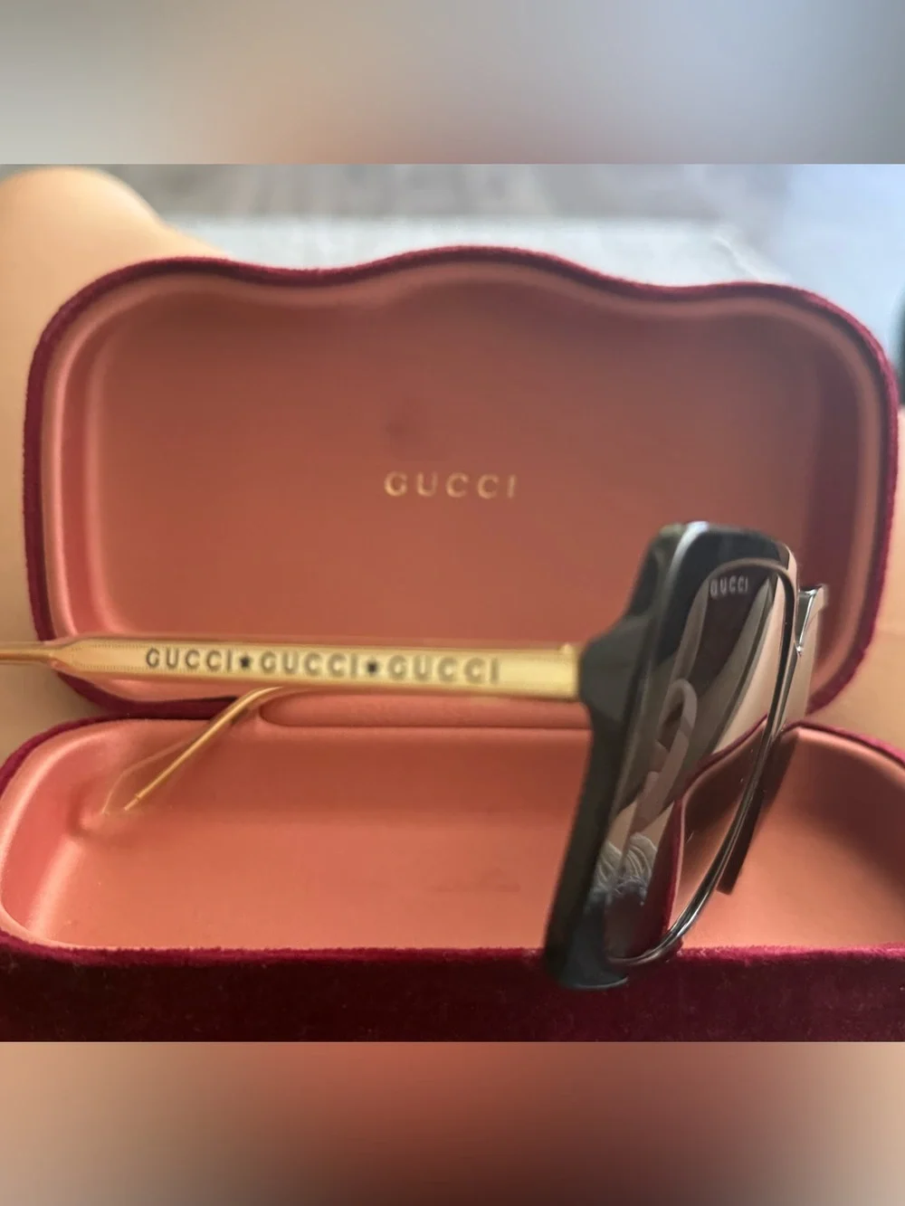 Gucci Black Frame Sunglasses with Gold Temples and Gray Lenses
